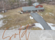 Front exterior of country home for sale at 133 Fort Henry Road in Bethel Pennsylvania with long driveway and wooded setting